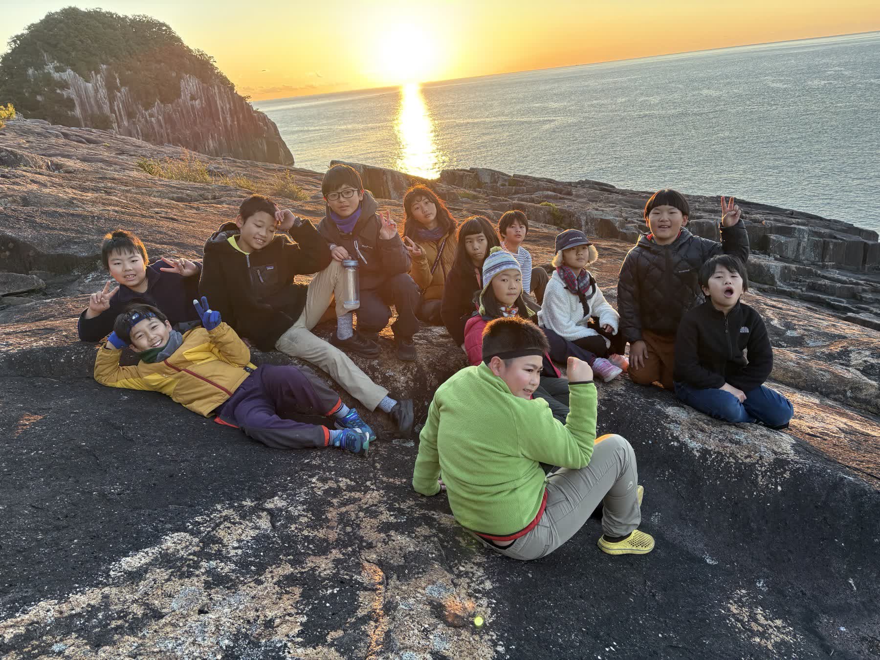 海辺で夕日を見る深山組の子どもたち